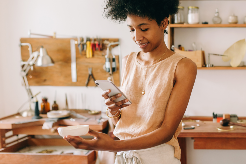 A brand owner takes a photograph of her product.