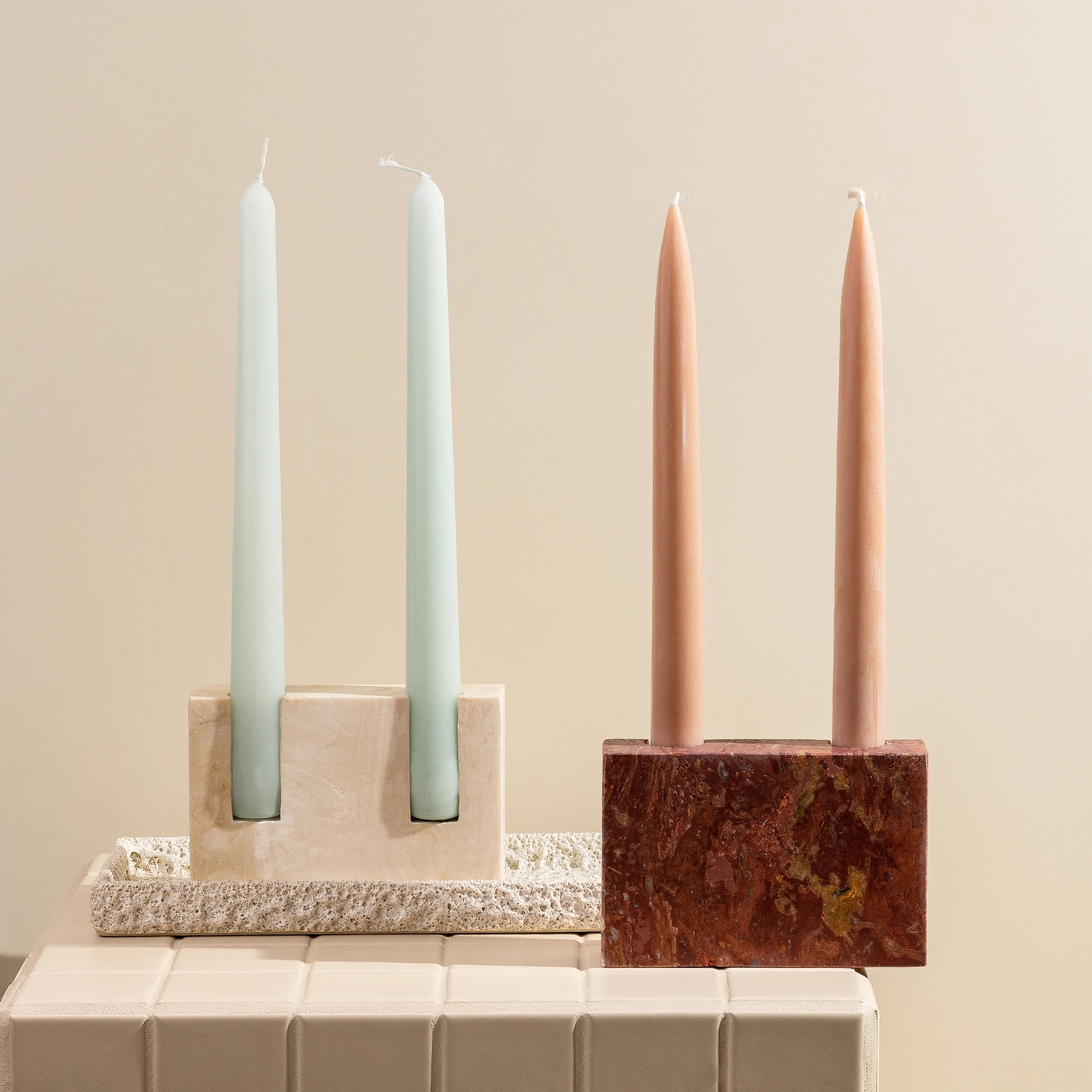 4 pillar candles in rustic candle holders.