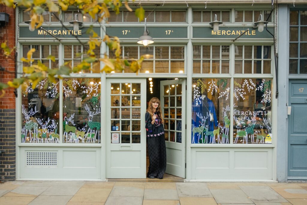 Retail store owner opening door to their shop.