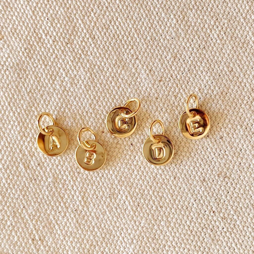 Gold letter charms for jewelry.
