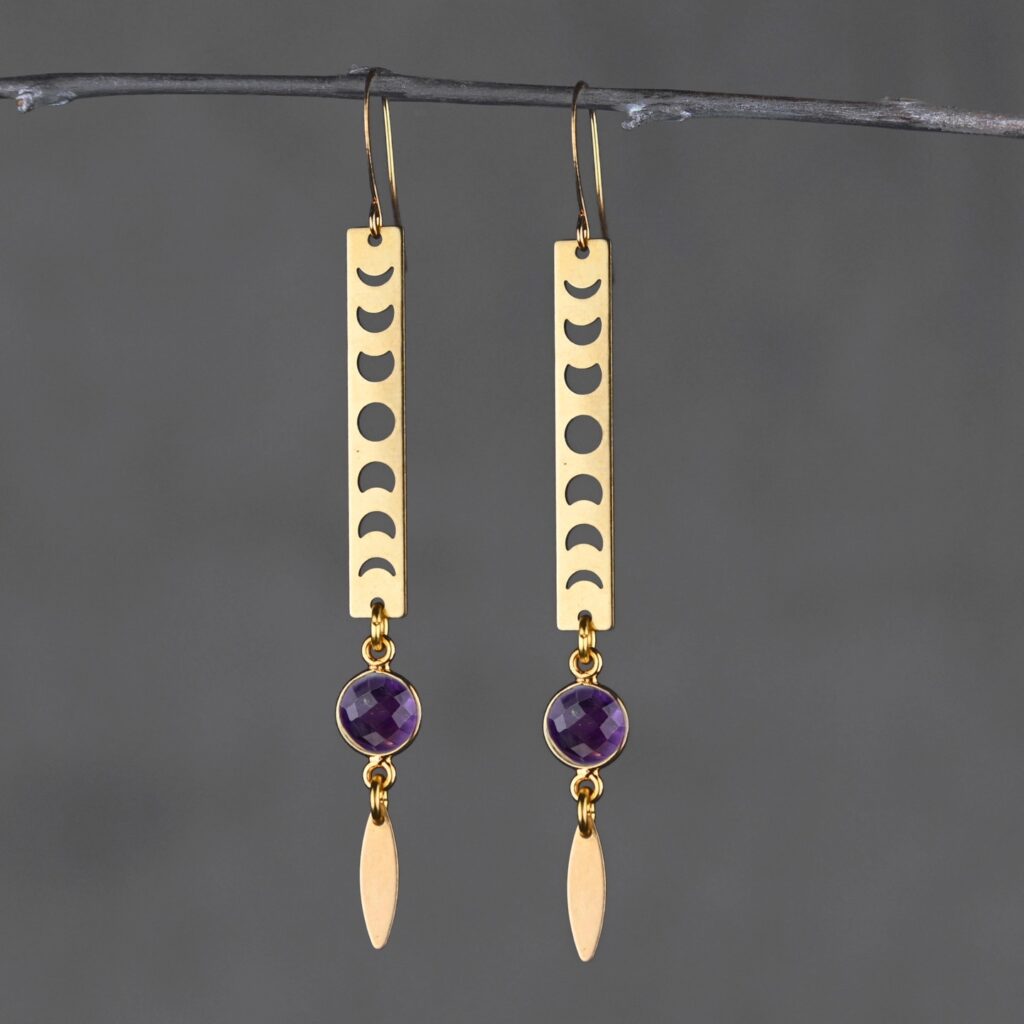 Pair of earrings with moon phases and marquise stone.