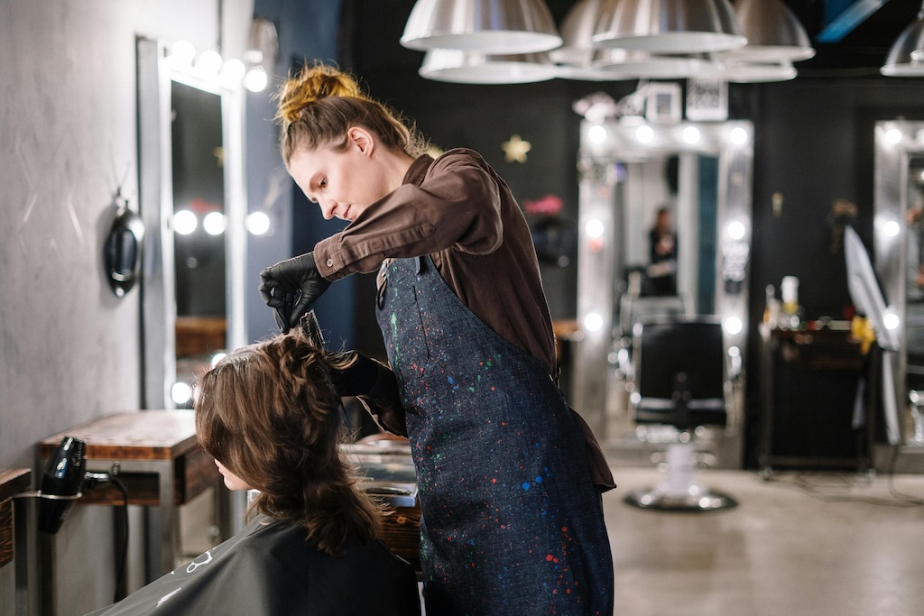 a hairdresser cuts a client's hair