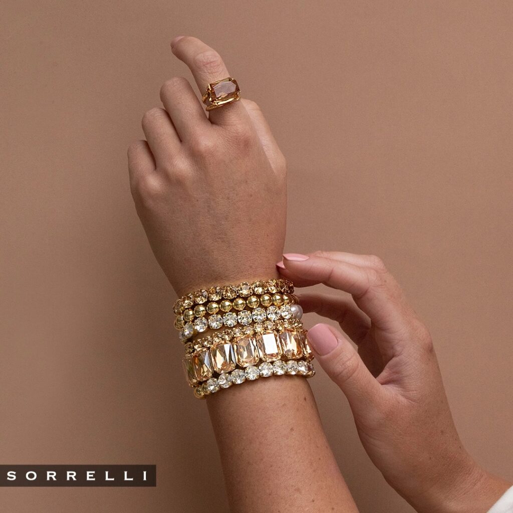 Woman wearing 10k gold bean bracelet.